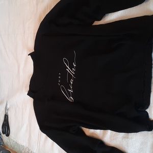 Unisex, size large, Just Breathe, black v-neck top with push back ribbed sleeve